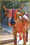 Colorful painted bull statue outdoors.