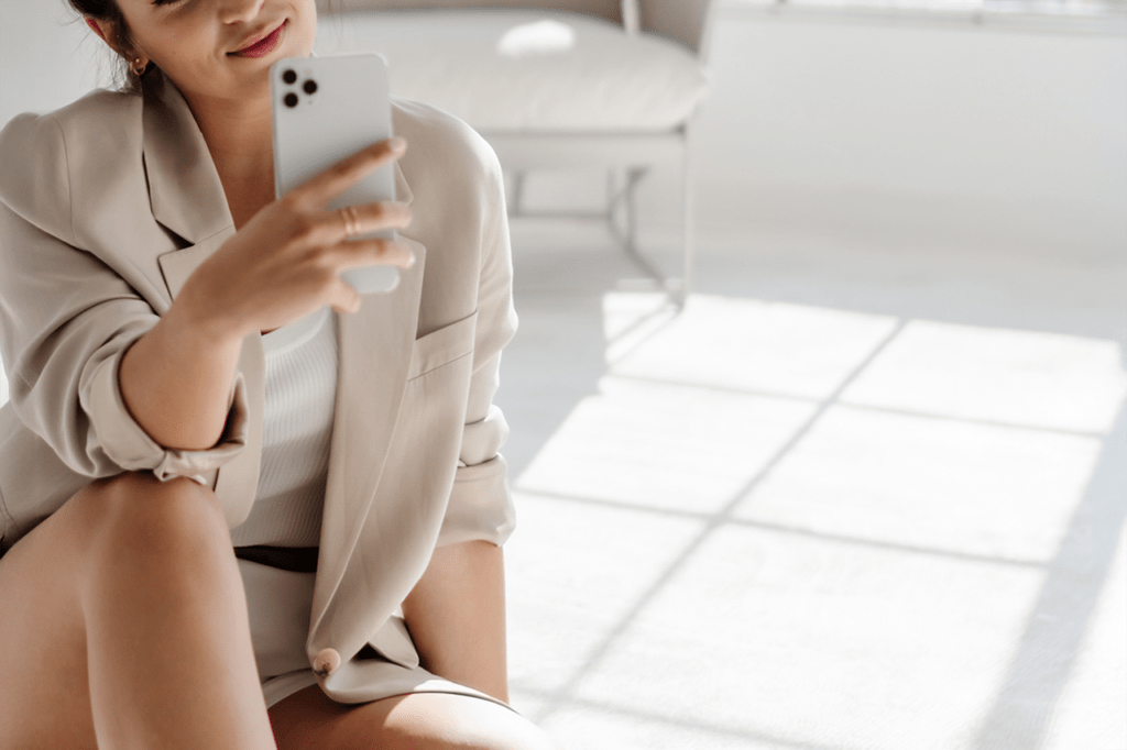 Woman taking selfie indoors with smartphone