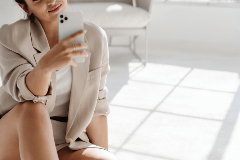 Woman taking selfie indoors with smartphone