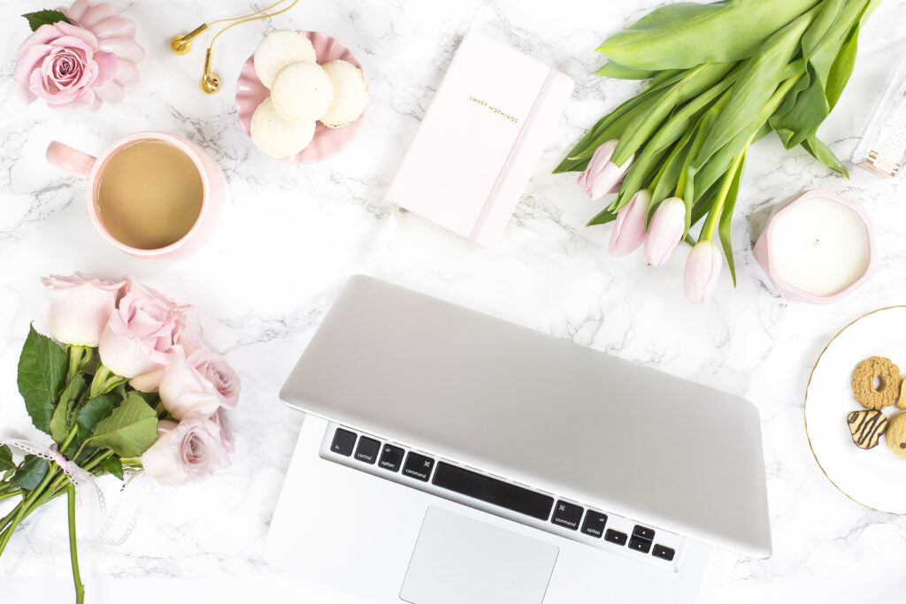 Elegant workspace with flowers, laptop, and coffee