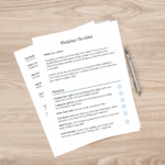 Blogging checklist with pen on wooden desk.