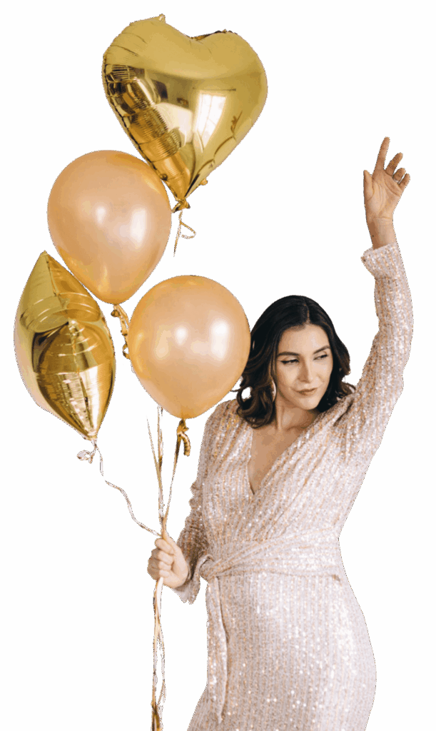 Woman celebrating with gold heart-shaped balloon.