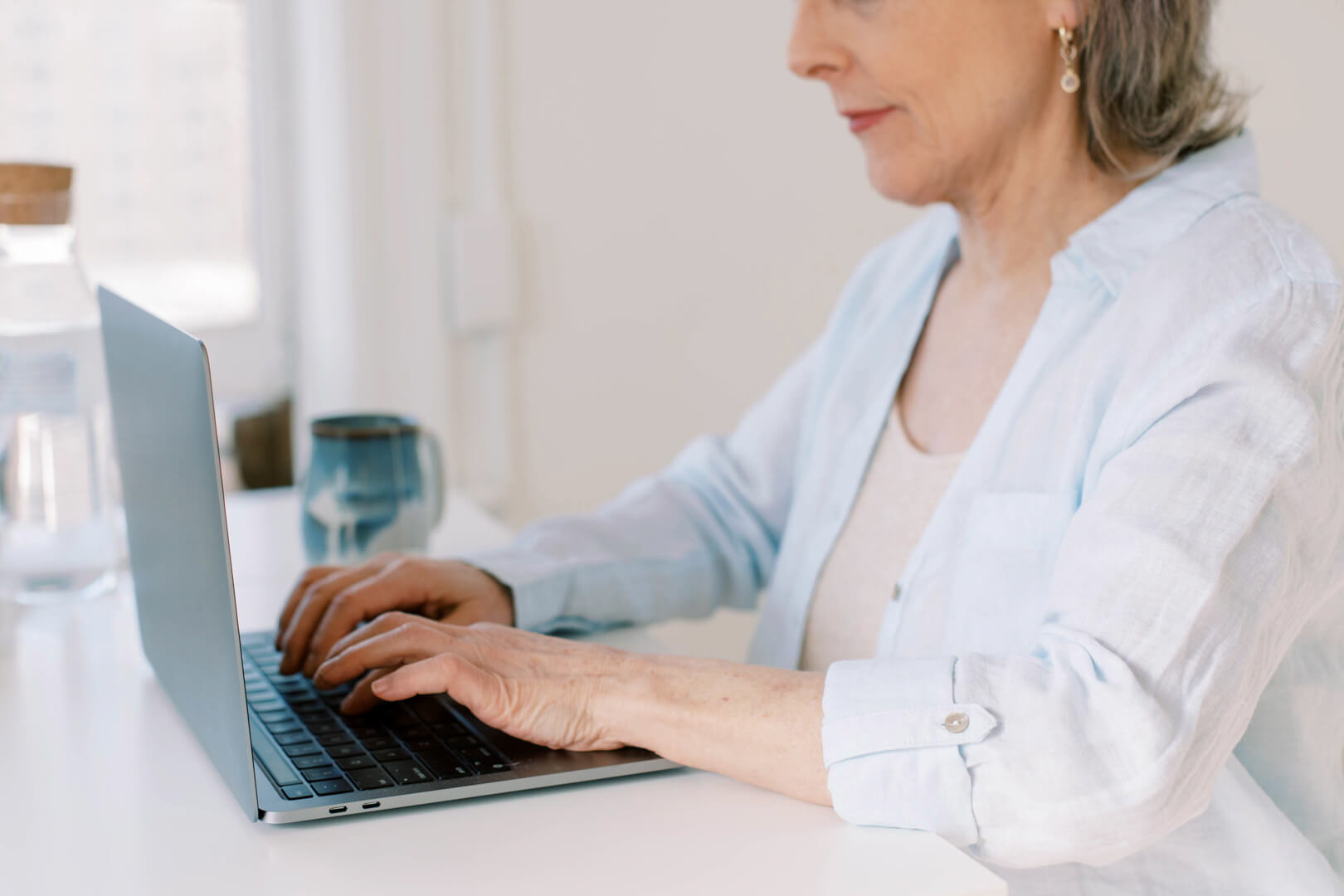 Woman typing on laptop at desk