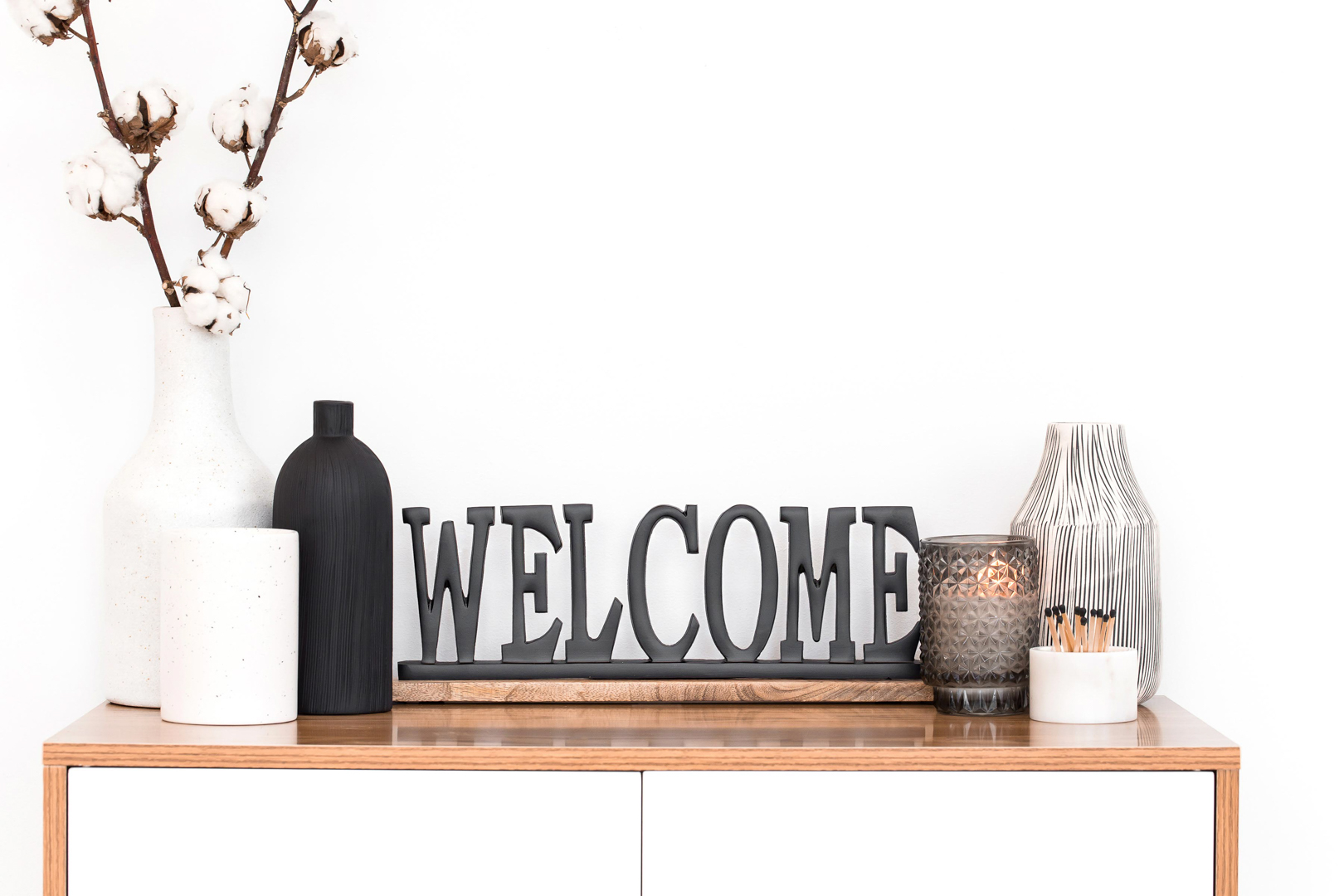 Modern decor with welcome sign and vases