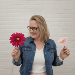 Smiling woman holding pink flowers