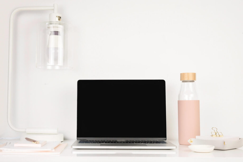 Minimalist desk with laptop and lamp