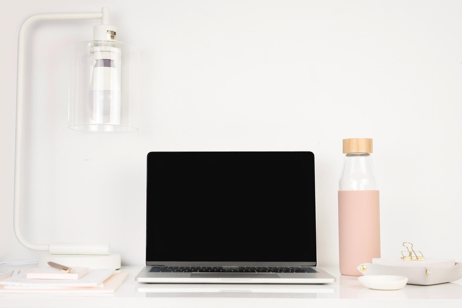 Minimalist desk with laptop and lamp