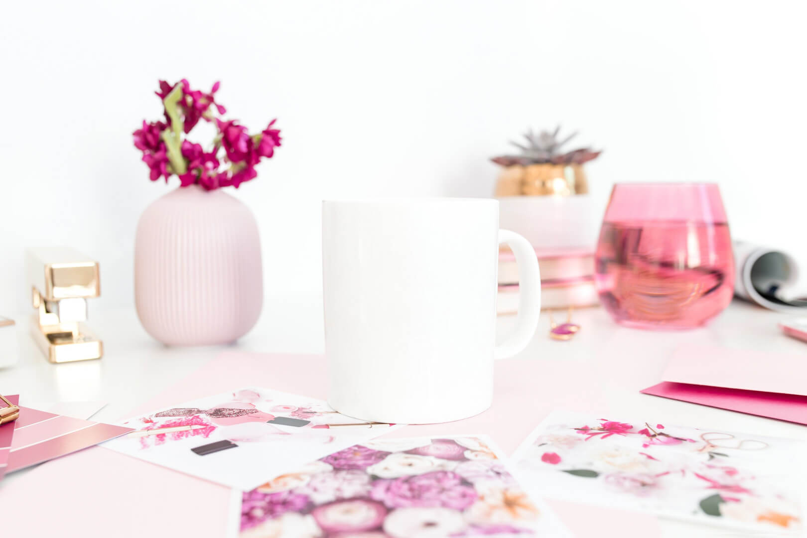 White mug on a pink-themed desk
