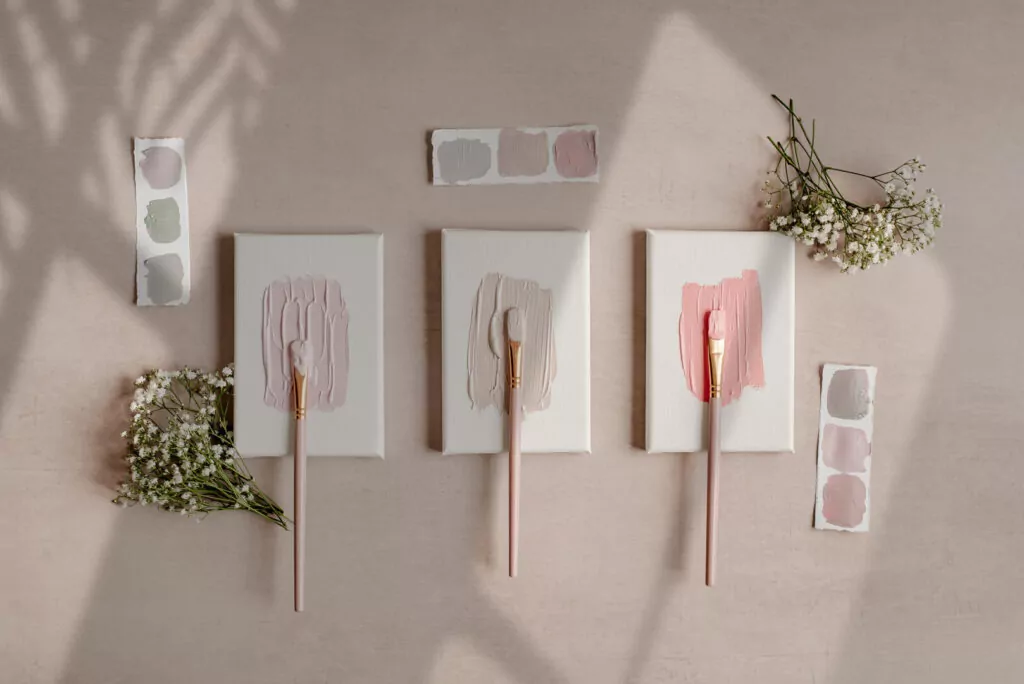 Pastel paint swatches and flowers on canvas