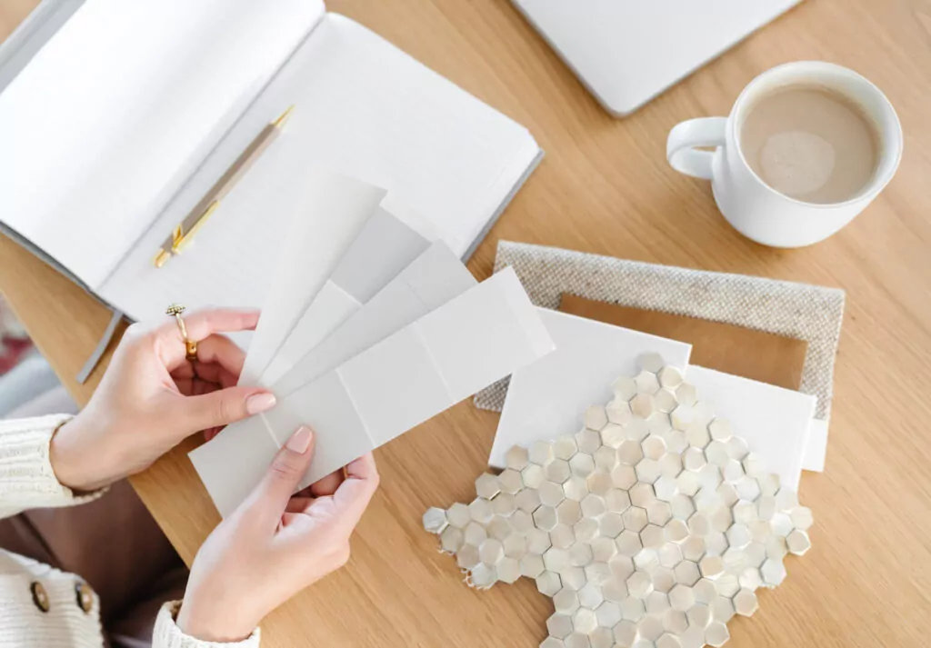 Person choosing paint colors and tiles