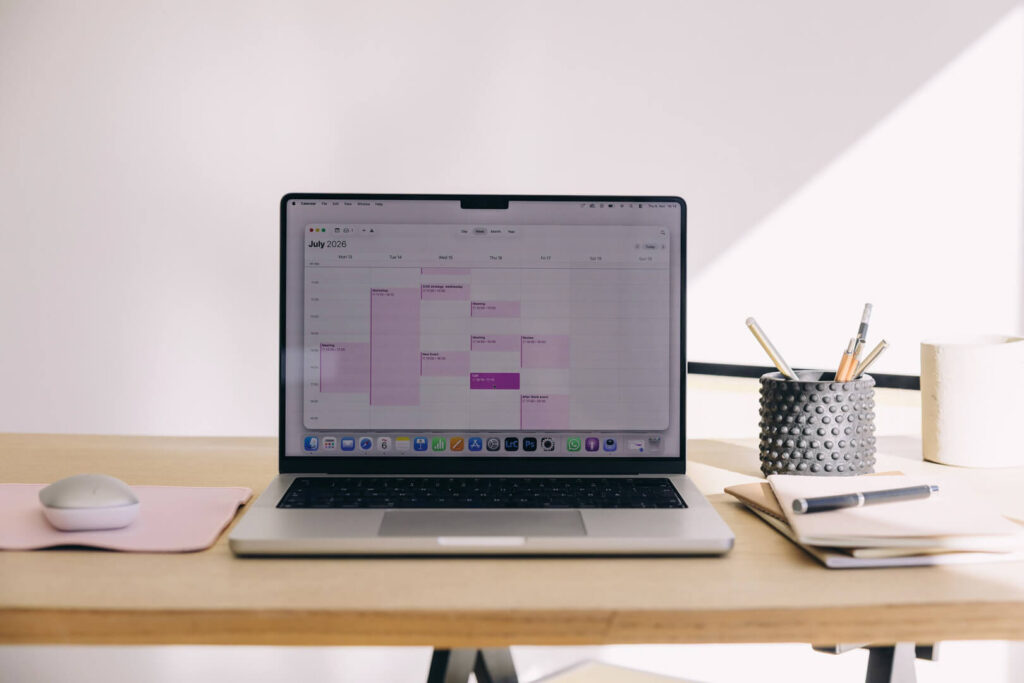 Laptop displaying calendar on minimalist desk setup
