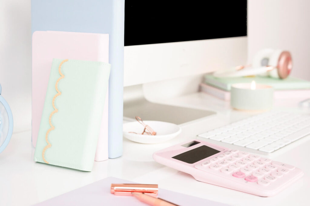 Pastel desk setup with calculator and computer