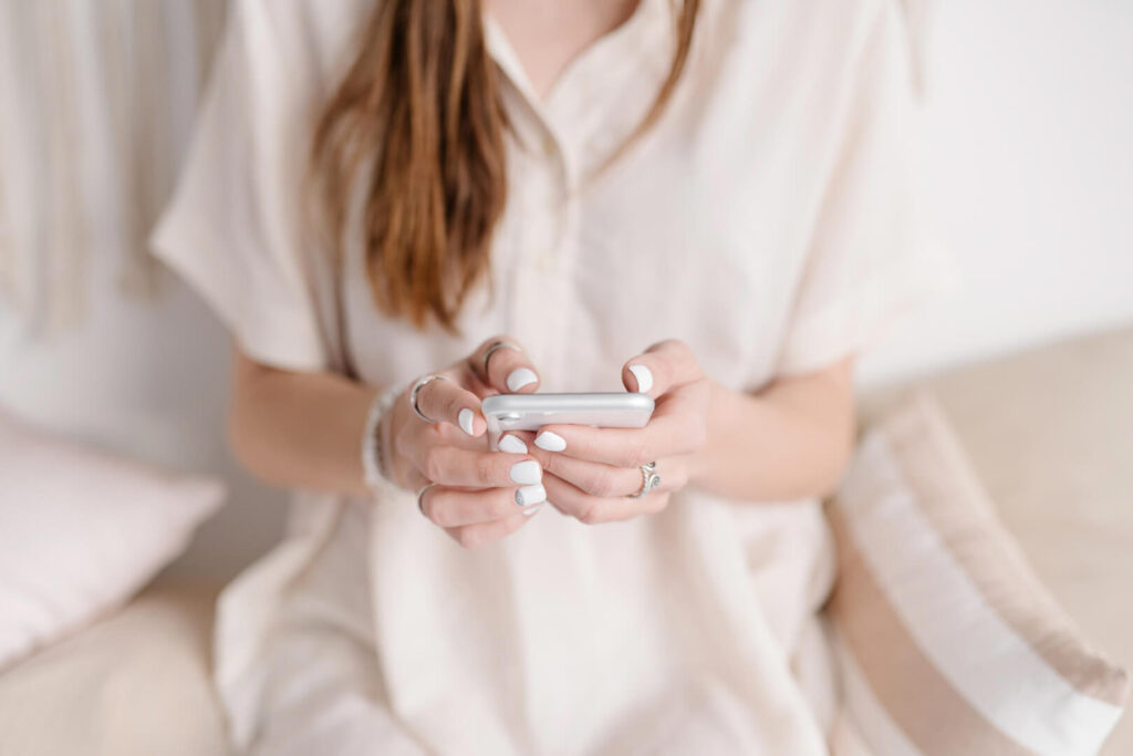 Person texting on a smartphone indoors