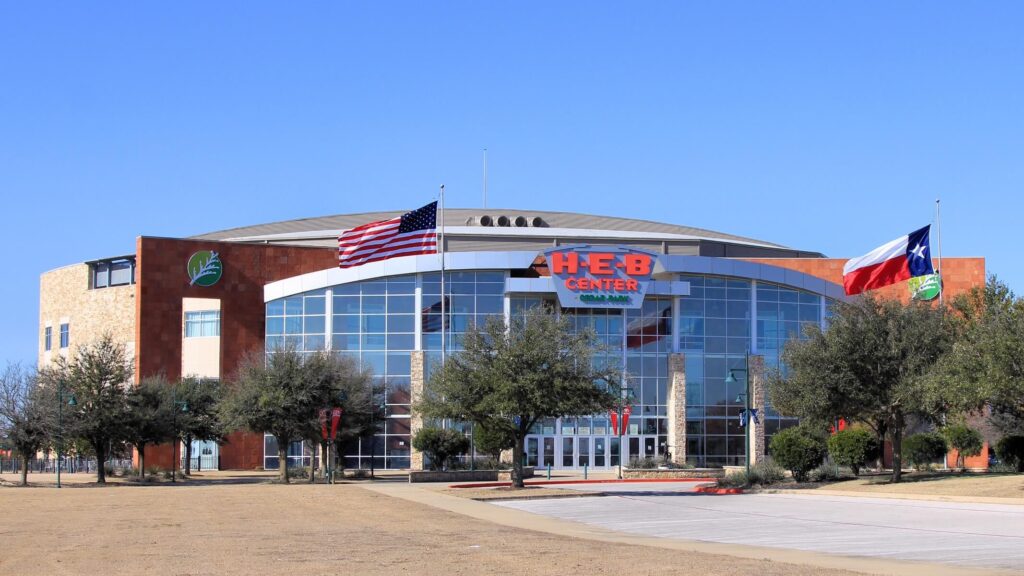 H-E-B Center arena entrance with American and Texas flags